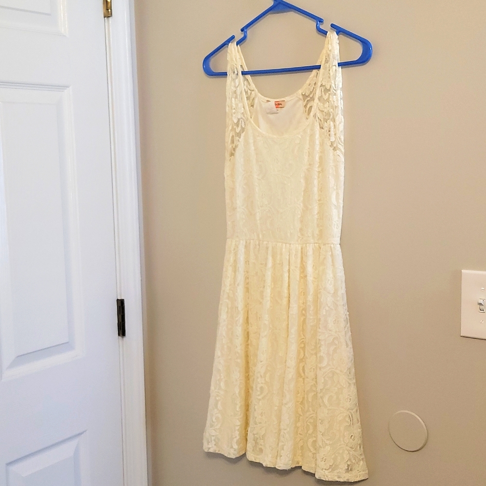 Cream colored , sleeveless lace dress